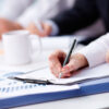 employer taking notes during meeting