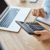 worker holding calculator