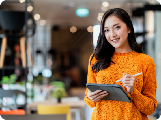 smiling woman holding tablet in office