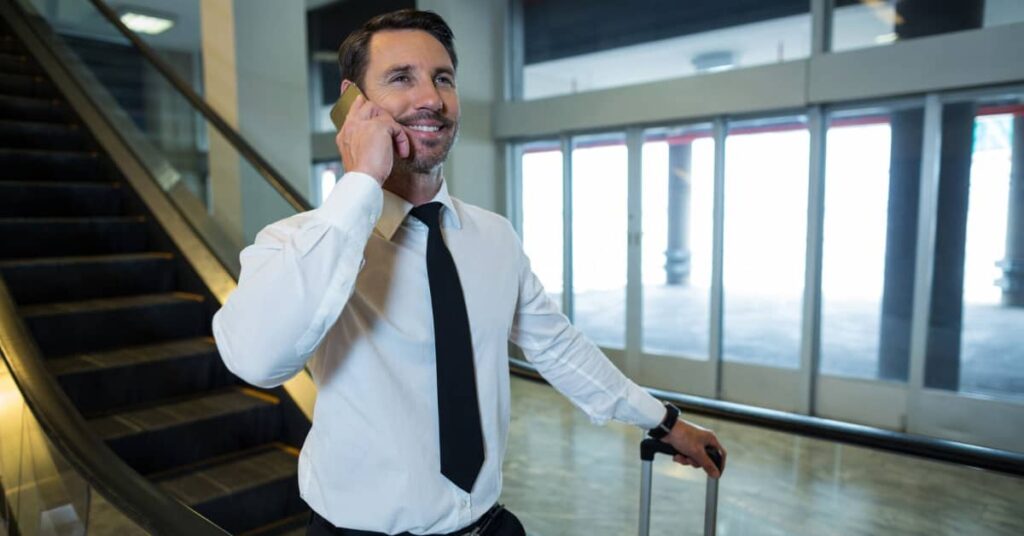 businessman on phone call with luggage