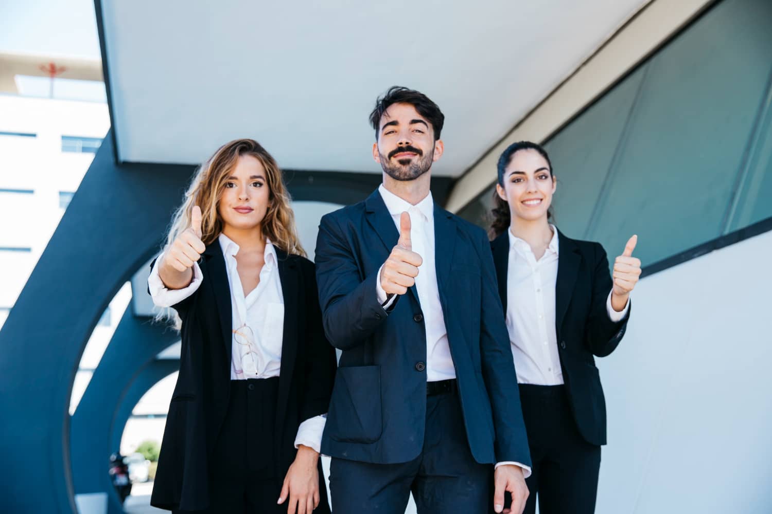 three coworkers giving thumbs up