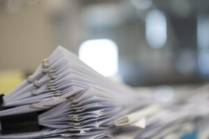 A large stack of organized business documents and paperwork for company registration in Singapore