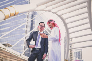 Business partners meeting outdoors in Singapore to discuss setting up a new company