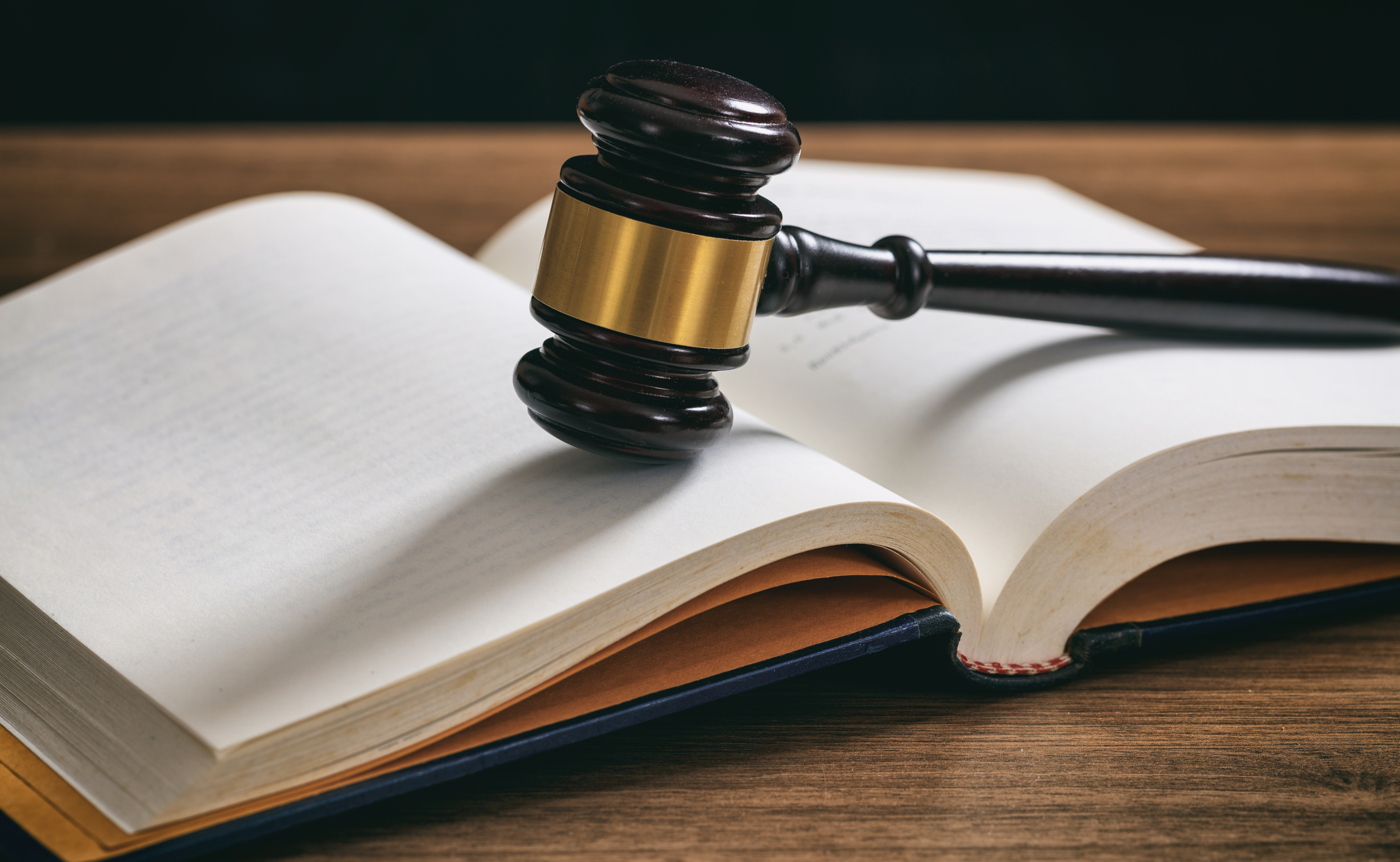 A judge's gavel resting on an open law book, symbolizing the legal framework for Singapore resident director requirements.