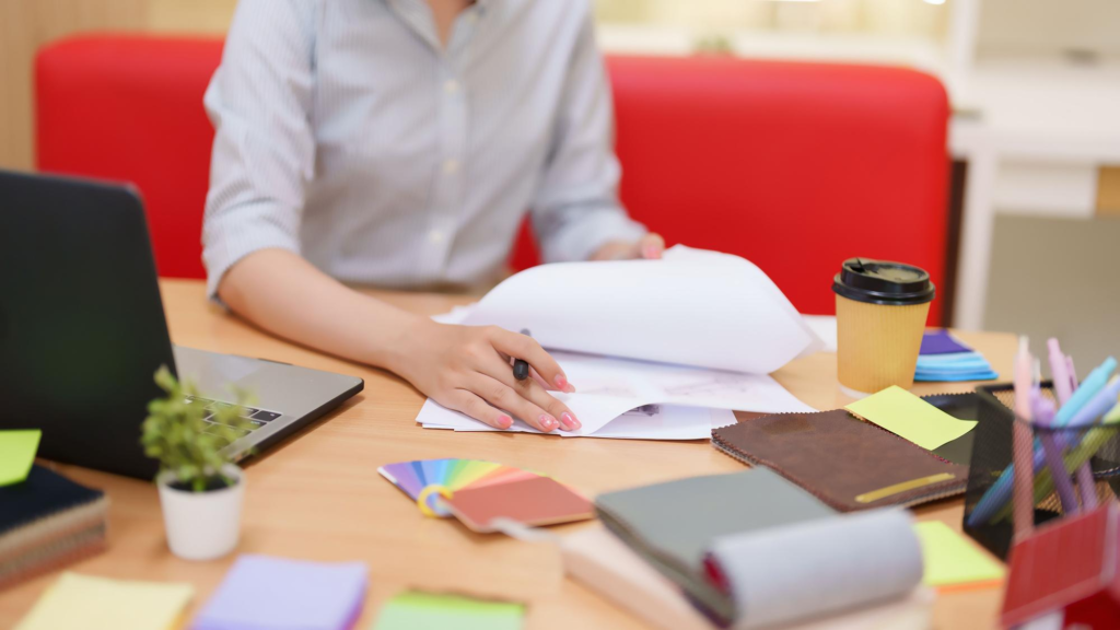 Woman working with papers on desk