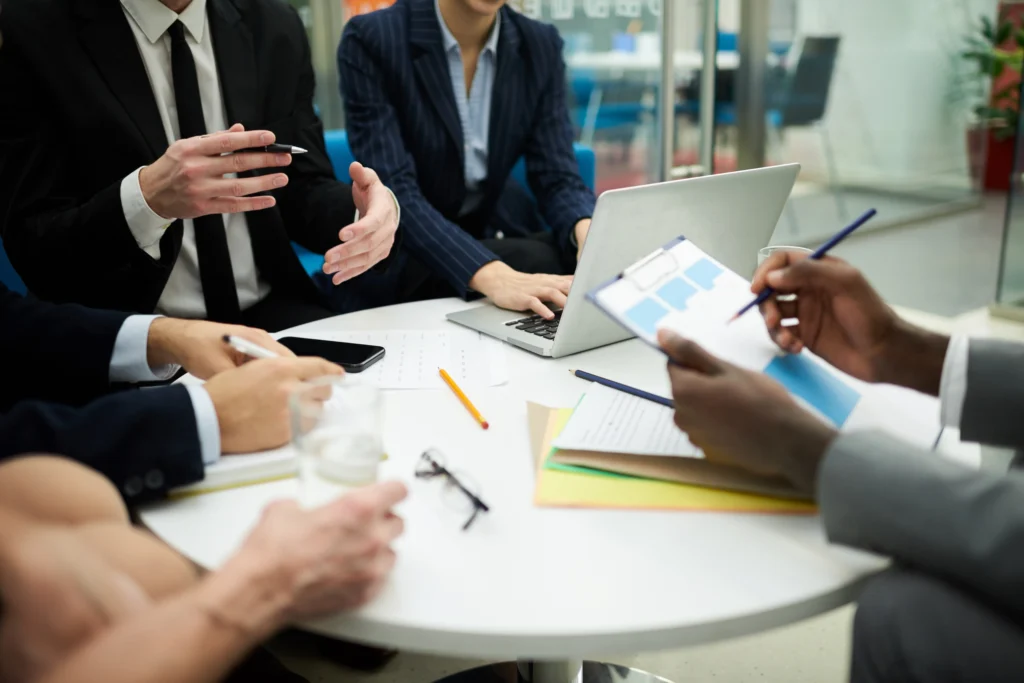 a professional business team sitting around a table discussing tax strategies and reports during a corporate meeting